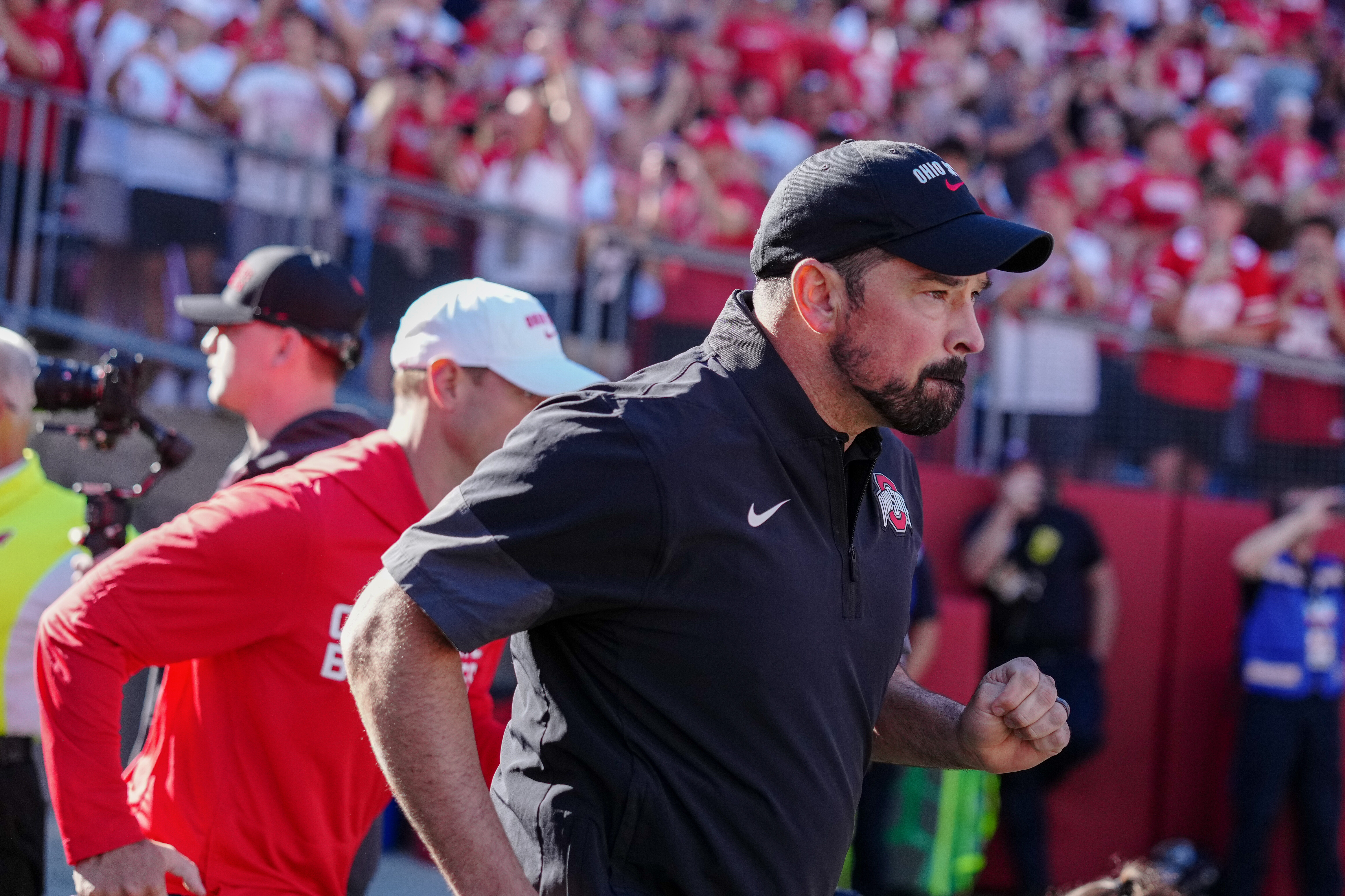 Oct 18, 2025; Madison, Wisconsin, USA; Ohio State Buckeyes head coach Ryan Day leads his team onto the field before a college football game between the Wisconsin Badgers and the Ohio State Buckeyes at Camp Randall Stadium on October 18, 2025 in Madison, Wisconsin. Photography by Ross Harried for Second Crop Sports.